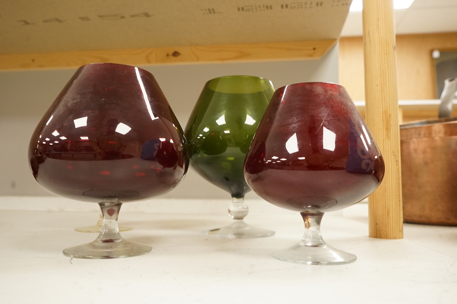 Five pieces of glassware to include a Swedish oversized brandy balloon, red glass sweetmeat dish and cover and a vase, largest 28cm high